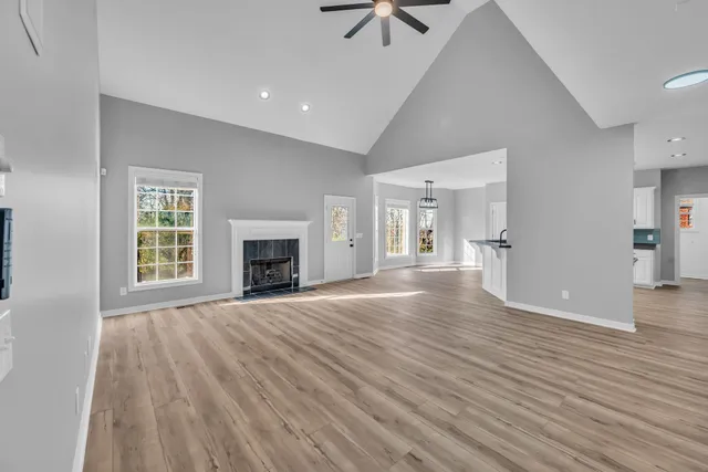 a view of empty room with wooden floor and fireplace