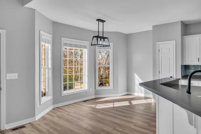 a kitchen with granite countertop a sink and a window