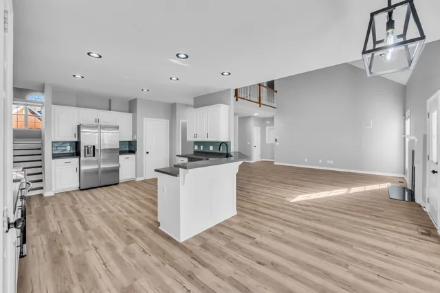 a view of kitchen with refrigerator microwave and stove