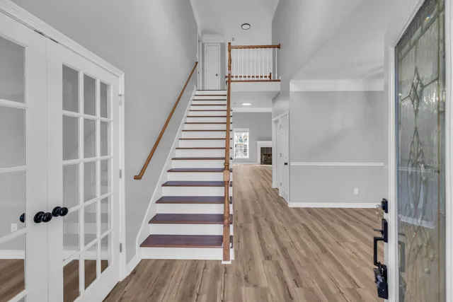 a view of entryway with wooden floor and stairs