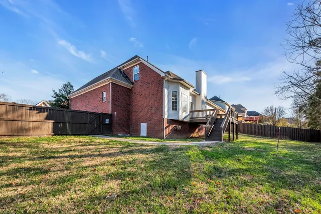 a view of a house with a yard and sitting area