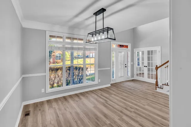 a view of a room with wooden floor staircase and windows