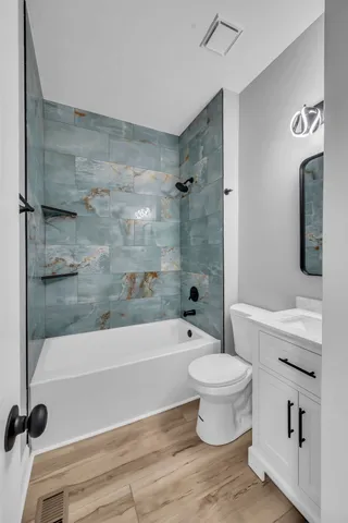 a bathroom with a bathtub and a toilet