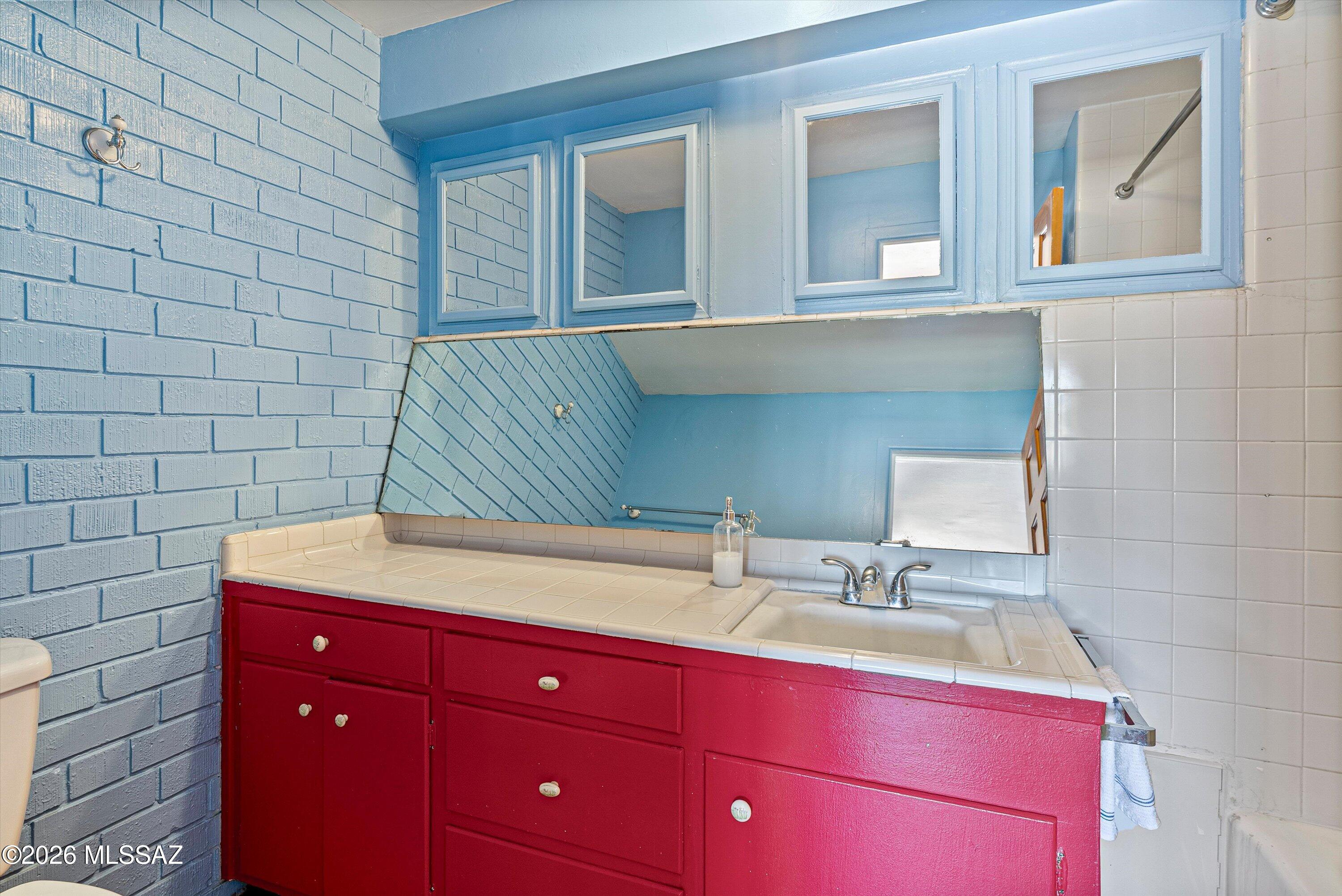 2107 East Lind Road Tucson, AZ 85719 - Photo 21 of 43 a bathroom with a sink and a mirror