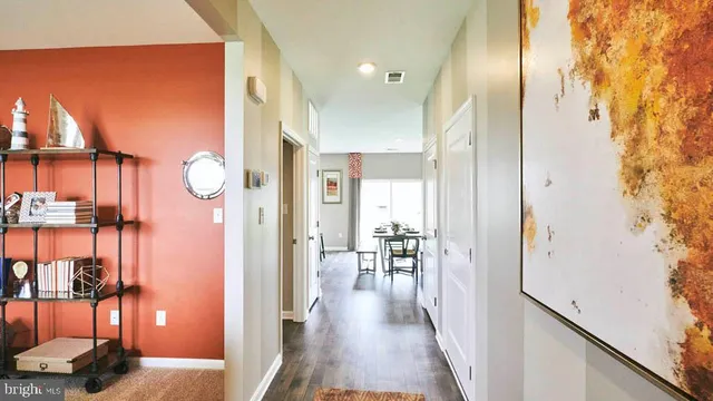 a view of a hallway with furniture and floor to ceiling window