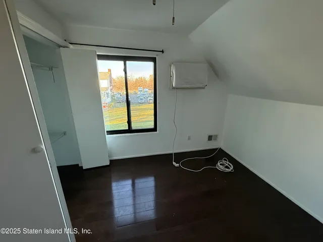 an empty room with wooden floor and door