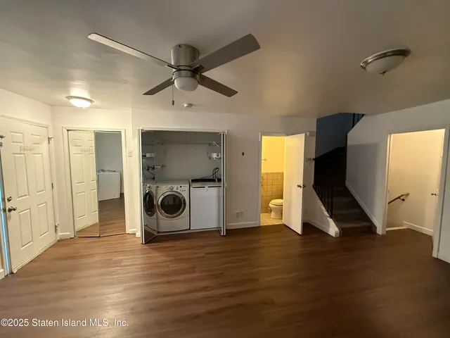 a view of an empty room and wooden floor