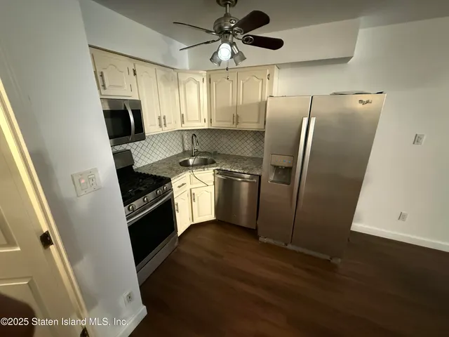 a kitchen with stainless steel appliances a refrigerator a sink a stove a microwave and island