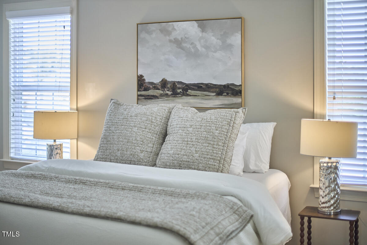 808 Historian Street Raleigh, NC 27603 - Photo 30 of 51 a bedroom with a bed and lamp