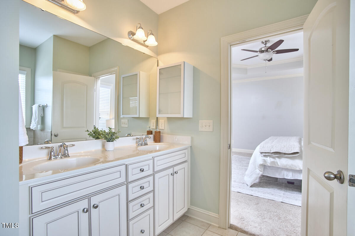 808 Historian Street Raleigh, NC 27603 - Photo 34 of 51 a en suite bathroom with a double vanity sink and a mirror