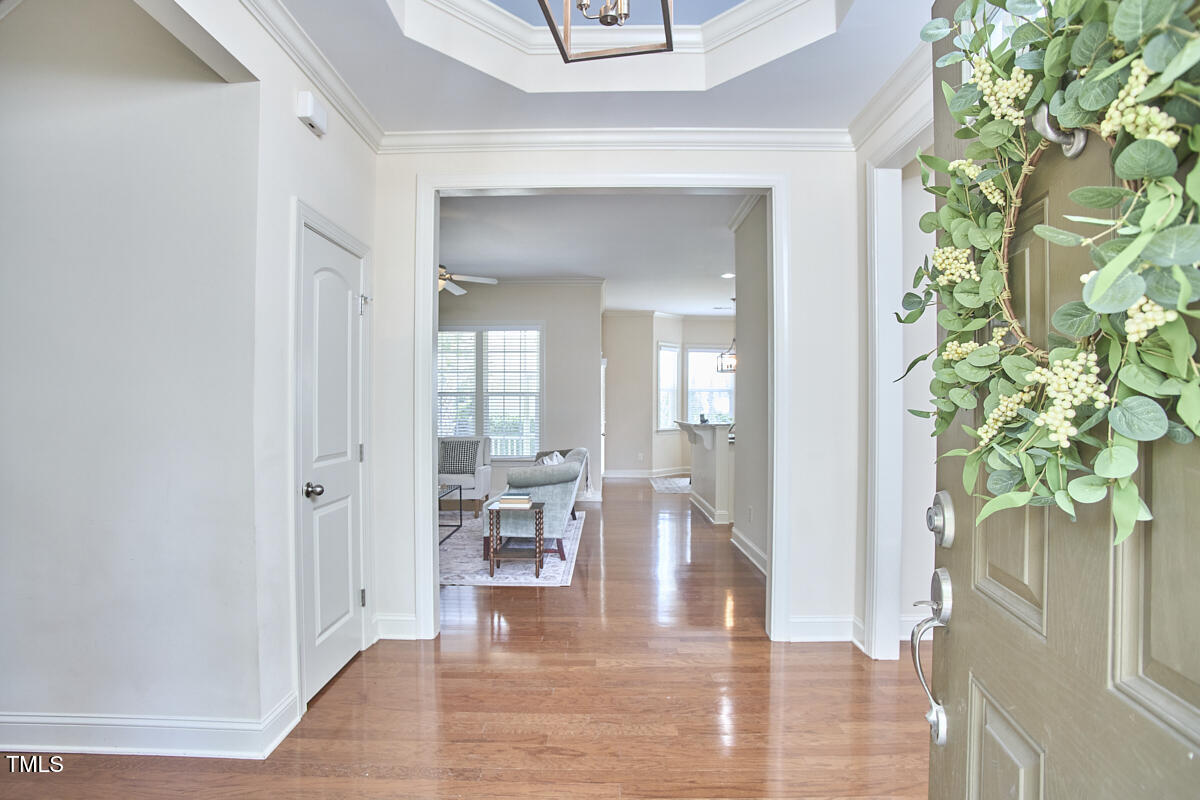 808 Historian Street Raleigh, NC 27603 - Photo 5 of 51 a view of a hallway with wooden floor and a potted plant