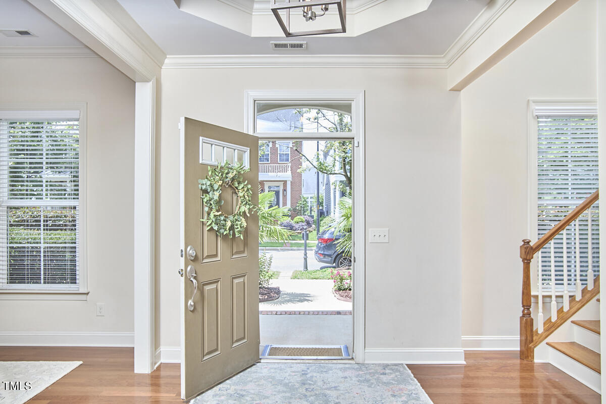 808 Historian Street Raleigh, NC 27603 - Photo 6 of 51 a view of an entryway with wooden floor and a window