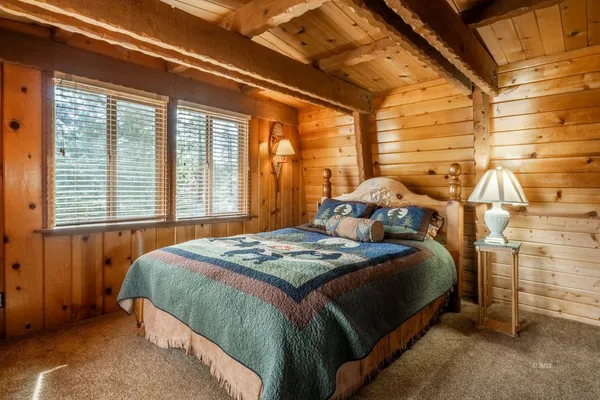 a bedroom with a bed and a table