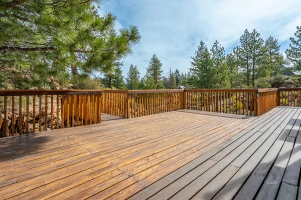 a view of a yard with wooden fence and trees