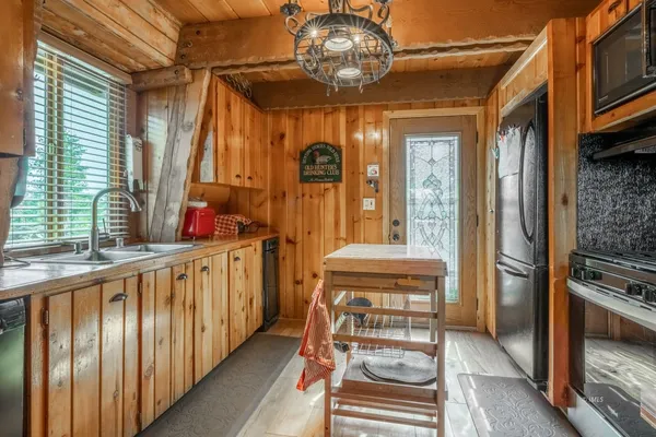 a kitchen with stainless steel appliances granite countertop a stove and a microwave oven