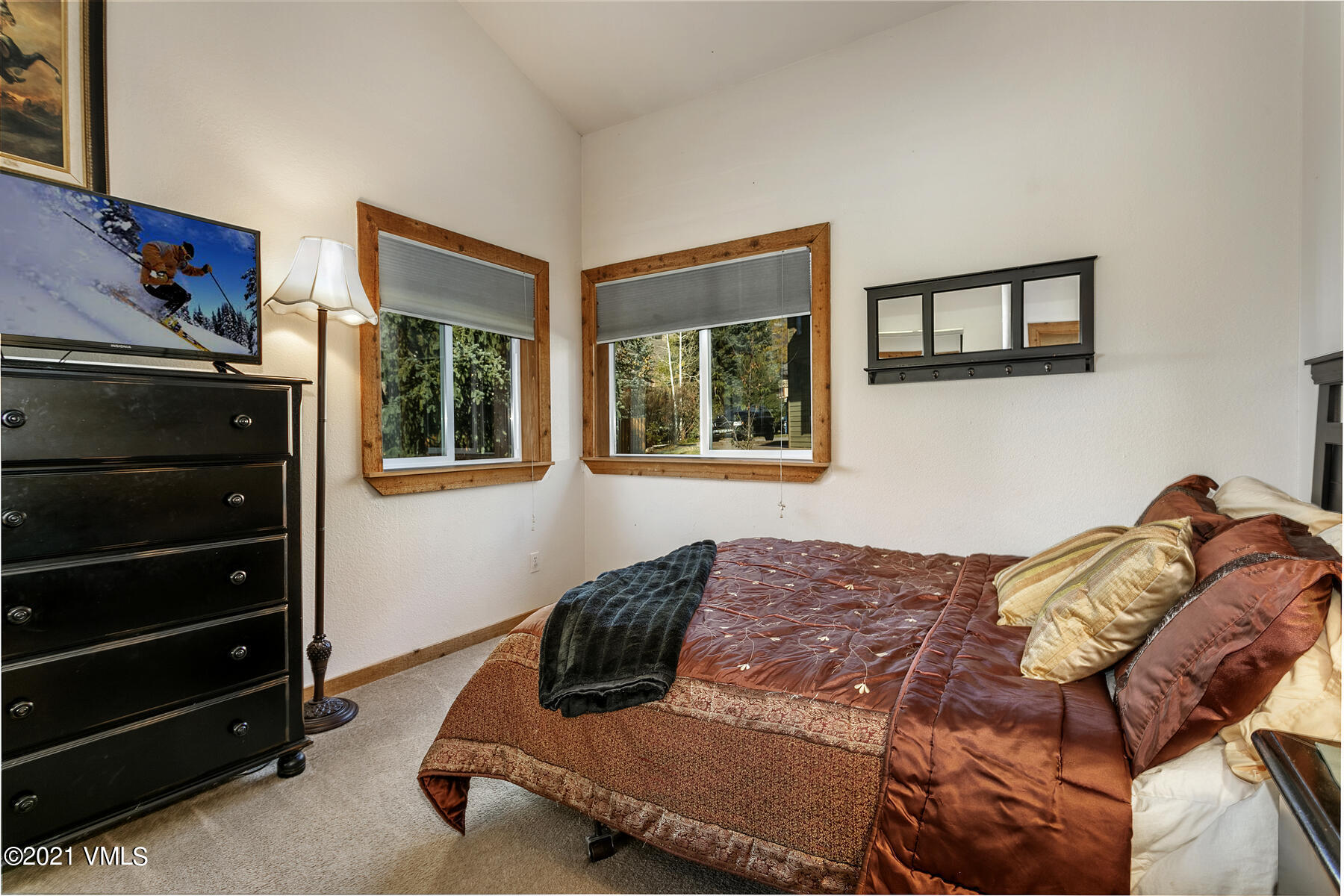 31 Beaver Road, Unit B Avon, CO 81620 - Photo 16 of 34 a living room with a bed and a dresser