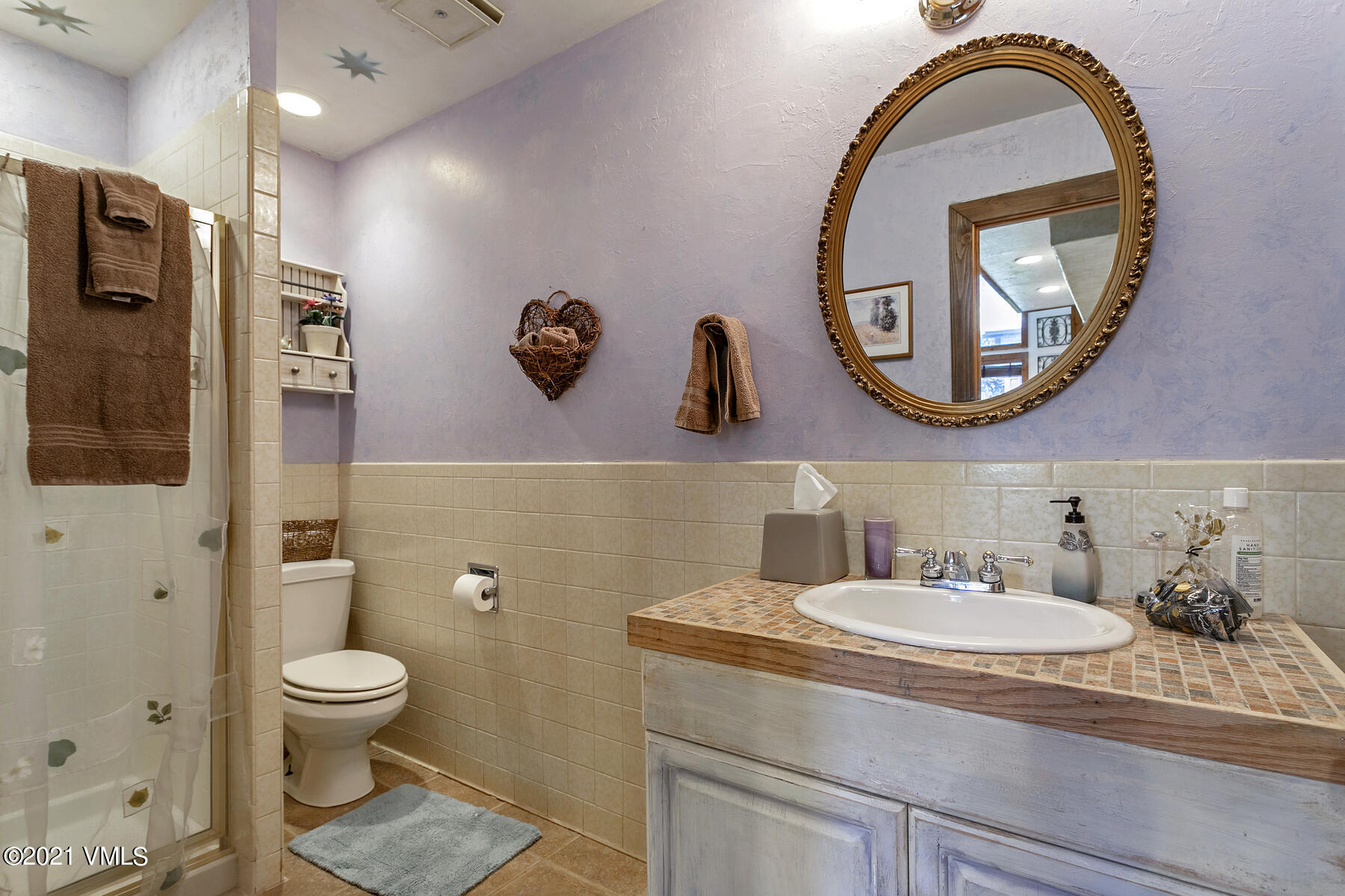31 Beaver Road, Unit B Avon, CO 81620 - Photo 18 of 34 a bathroom with a toilet a sink and a mirror