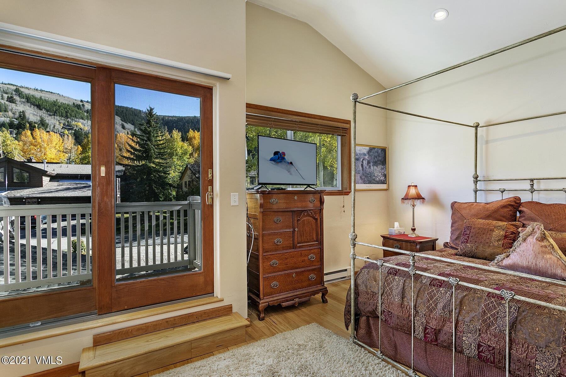 31 Beaver Road, Unit B Avon, CO 81620 - Photo 20 of 34 a bedroom with a bed and wooden floor