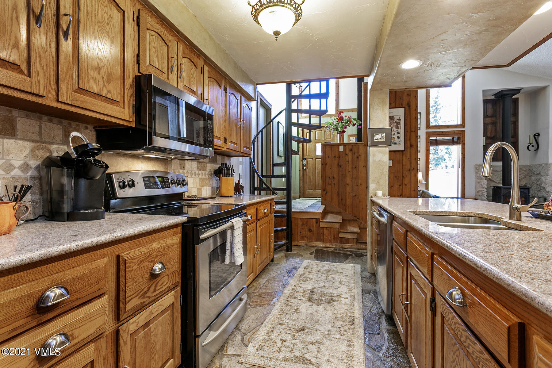 31 Beaver Road, Unit B Avon, CO 81620 - Photo 6 of 34 a kitchen with stainless steel appliances granite countertop a sink a stove and cabinets