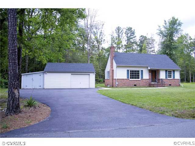 9103 Peaks Road Ashland, VA 23005 - Photo 1 of 12 a front view of a house with a garden and yard