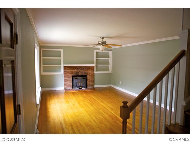 9103 Peaks Road Ashland, VA 23005 - Photo 3 of 12 a view of empty room with wooden floor and fireplace