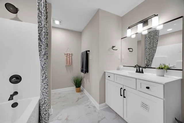 a bathroom with a bathtub and a shower