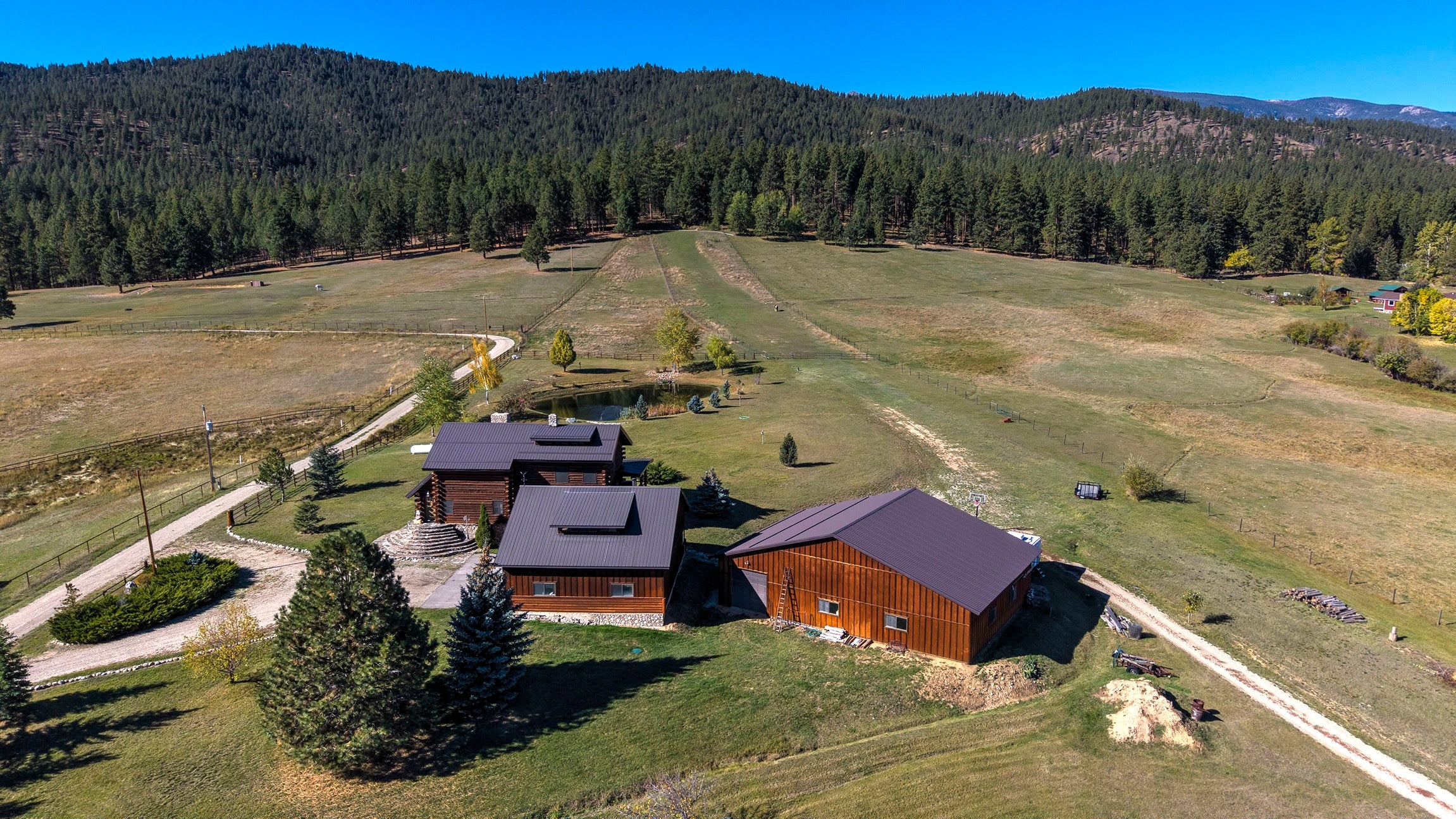 203 Hart Bench Road Darby, MT 59829 - Photo 52 of 56 Your own Montana ?Last Best Place? awaits, with peaceful Forest Service borders, stunning panoramic views, and a serene pond for ultimate relaxation.