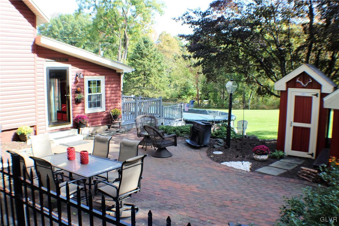 1967 Blue Barn Road Orefield, PA 18069 - Photo 6 of 35 a view of a patio with a dining table and chairs with wooden fence and plants