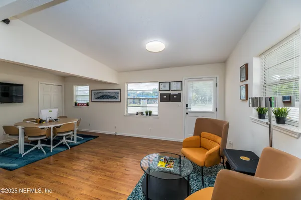 a living room with furniture and wooden floor