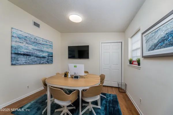 a dining room with furniture and wooden floor