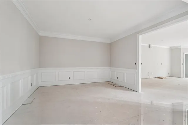 a view of an empty room with stairs and a view of shop