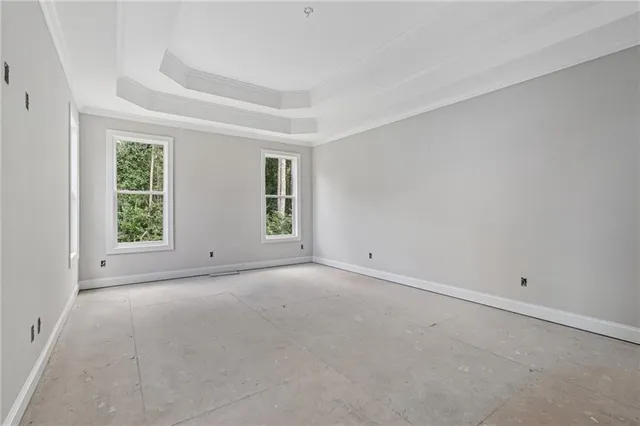 a view of an empty room with closet and a window