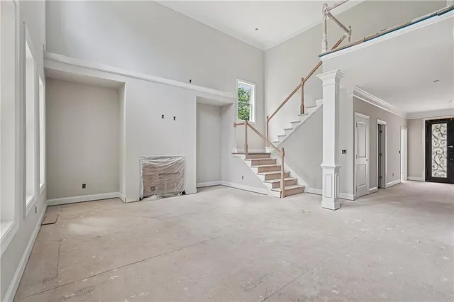 a view of a house with a big yard and large trees