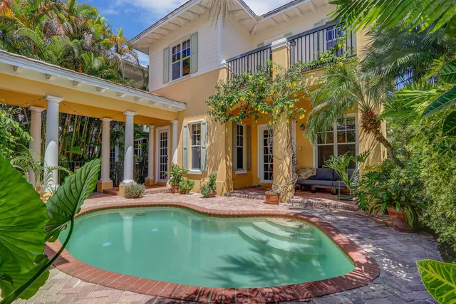 a view of a house with backyard porch and sitting area