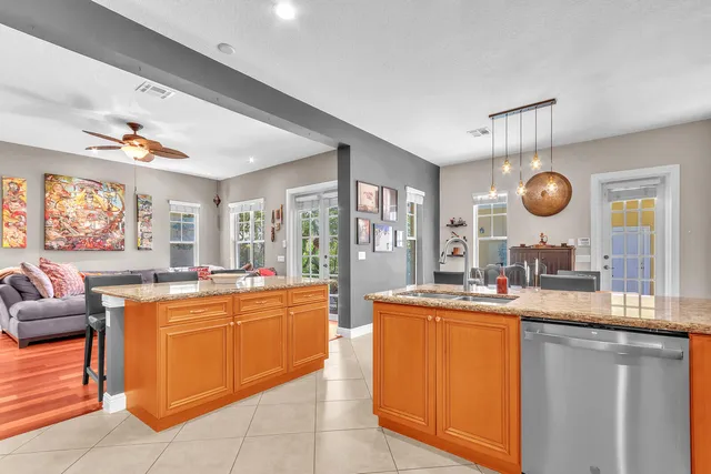 a kitchen with stainless steel appliances granite countertop a refrigerator a sink a stove and island