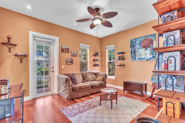 a living room with furniture and a book shelf
