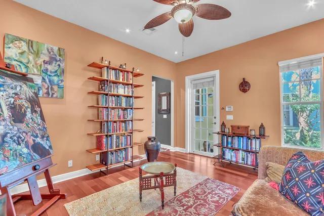 a living room with furniture and a book shelf