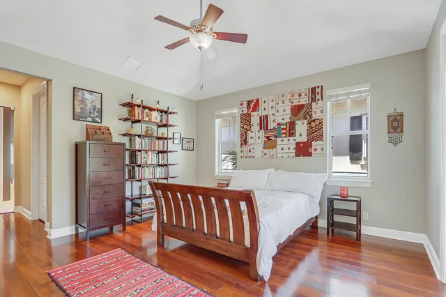 a bedroom with a bed and a chandelier