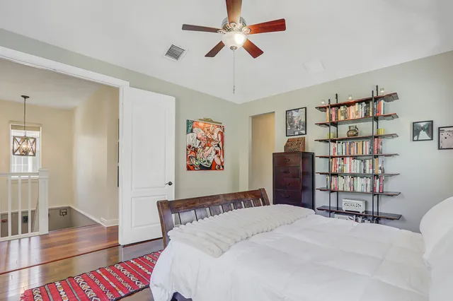 a balcony with table and chairs and wooden fence