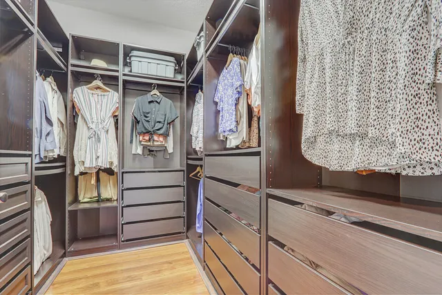 a bathroom with a sink a large mirror and a light fixture