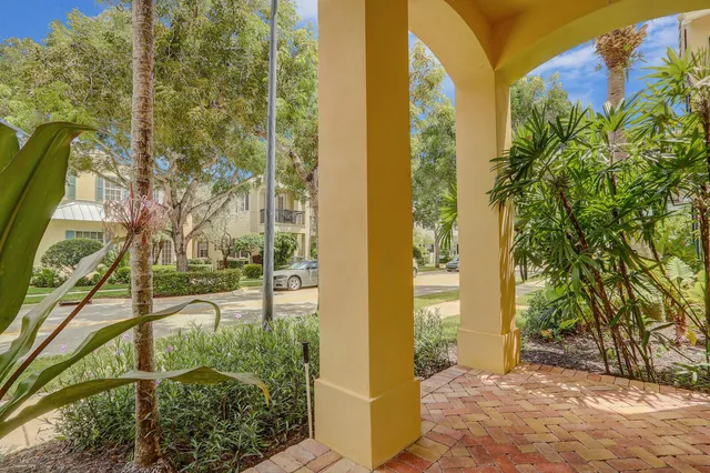 a living room with furniture kitchen view and a large window