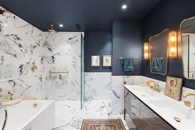 a bathroom with a tub sink and mirror