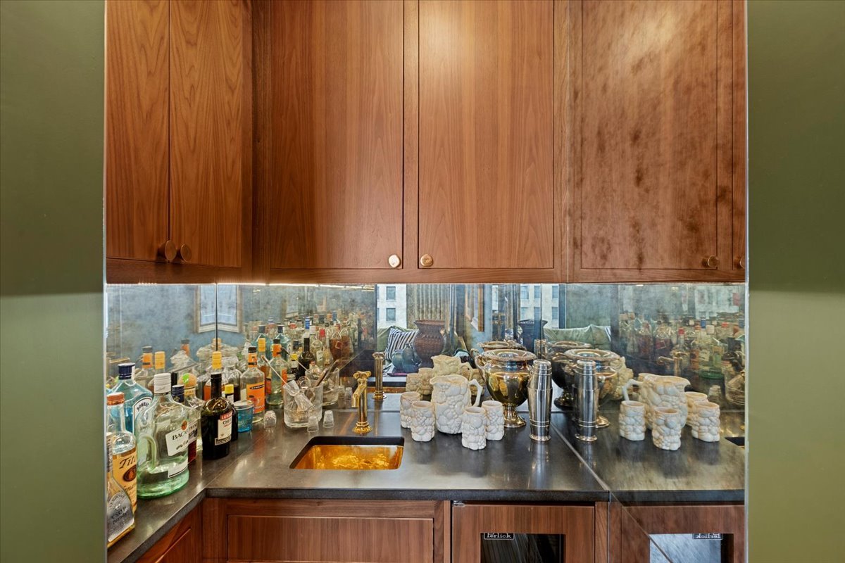159 East Walton Place, Unit 8C Chicago, IL 60611 - Photo 17 of 28 a kitchen with a sink and a stove with wooden floor