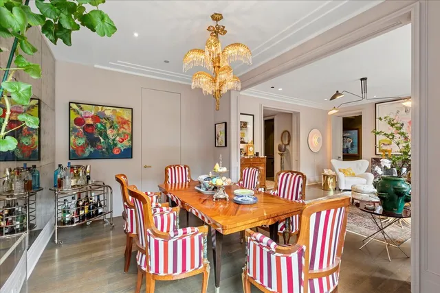 a view of a dining room with furniture a chandelier and wooden floor