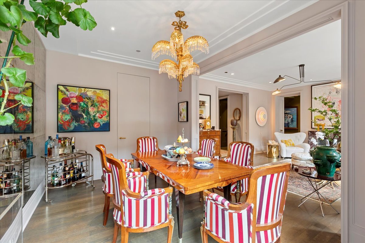 159 East Walton Place, Unit 8C Chicago, IL 60611 - Photo 19 of 28 a view of a dining room with furniture a chandelier and wooden floor