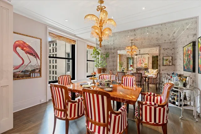 a group of dining room with furniture wooden floor and chandelier