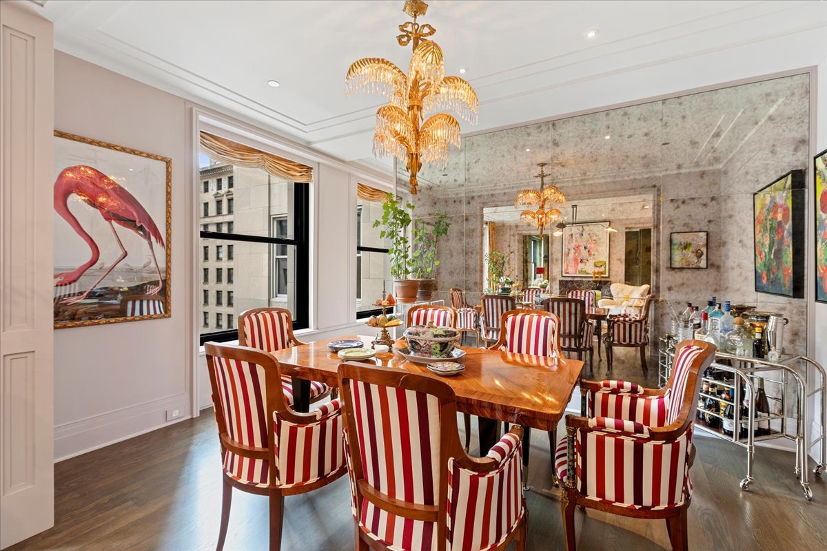 159 East Walton Place, Unit 8C Chicago, IL 60611 - Photo 20 of 28 a group of dining room with furniture wooden floor and chandelier