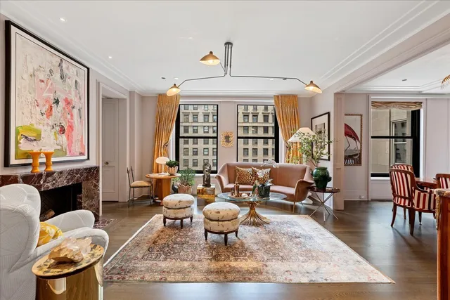 a living room with furniture fireplace and a large window