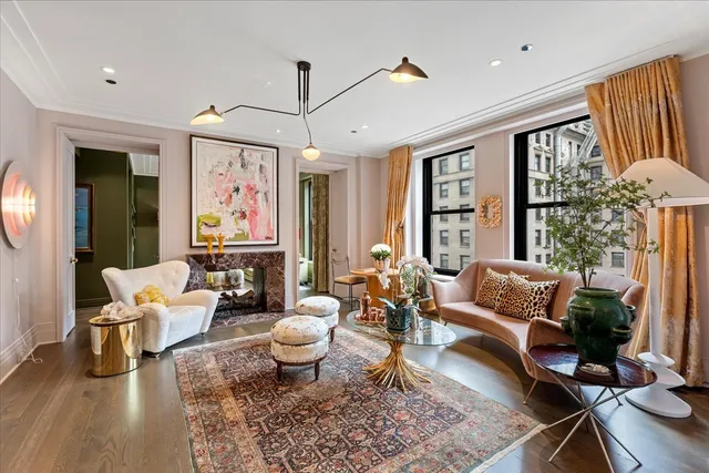 a living room with patio furniture and a large window