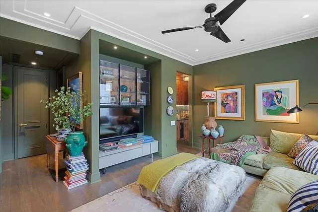 a bedroom with a bed a potted plant and a dresser